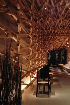 Seating area, wrapped in woven wood, looking back toward rear garden.