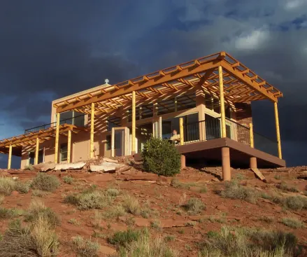 A large, sheltered porch provides shade and extends the interior living space.
