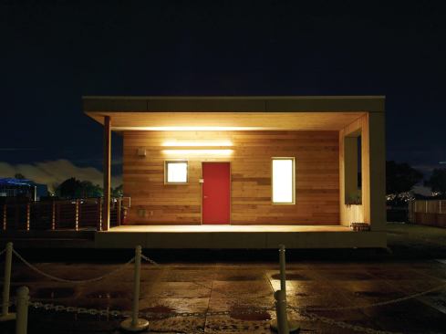 The house features a welcoming front porch, a private back porch with storage space, and an interior flex space that incorporates built-in shelving.