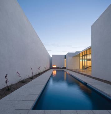 The house's side courtyard is shielded from view by the building and a high garden wall.