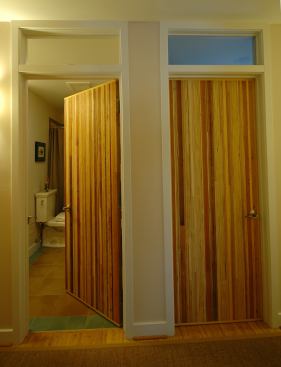 Interior doors were crafted by a local artist from discarded and reclaimed cabinet wood and rubbed with a no-VOC finish. DeChesere estimates the 1 3/4-inch-thick doors feature about 15 types of wood, including a cedar mantle from the existing house.
