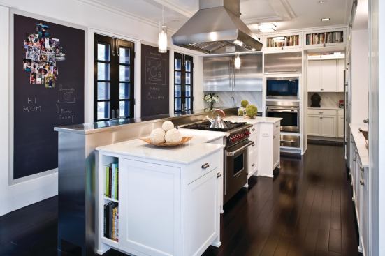 Trend #17: This modern bistro kitchen, designed by architect Robert J. Miller for a professional chef, has the requisite industrial-grade appliances, but also incorporates cost-saving materials such as chalkboard paint. A vegetable garden lies just outside the French doors.